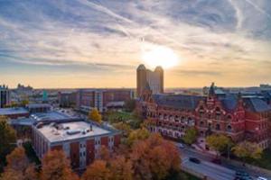 An aerial view of campus with the sun setting behind Gries Hall