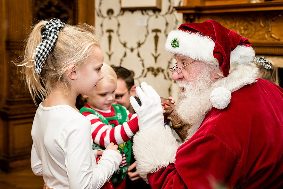 Santa talks to two children.