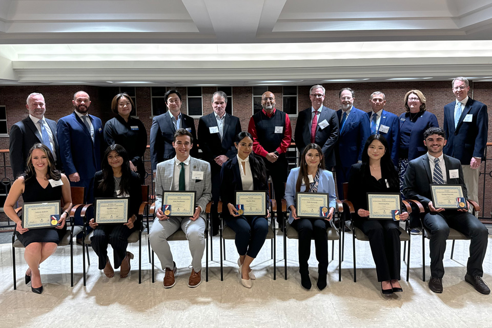 2024 International Business Awards Honorees Pose On Stage for a Group Photo with their Awards