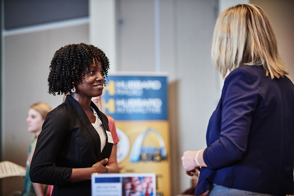 Student talks with employers at SLU career fair at the Busch Student enter