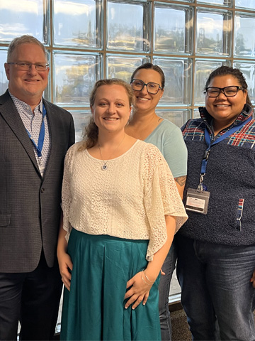 Elisabeth Demarco standing with Leslie Hinyard, Jeffrey Scherrer, and Divya Subraminum