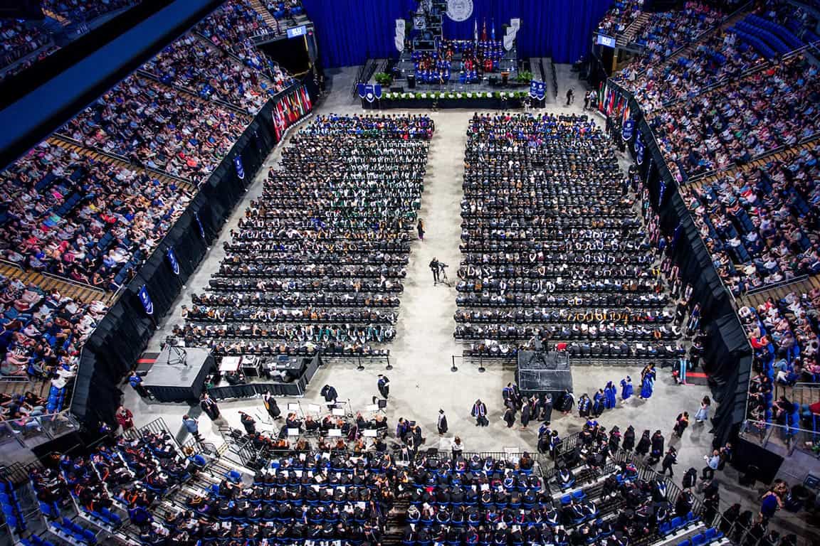 A birds-eye view of the Chaifetz Arena full of graduates and guests during the 2024 commencement.