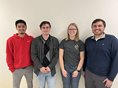 Adam Blank, Adrian Ortiz, Jaeden Sizemore, and Caitlin Zoschke posed against a wall