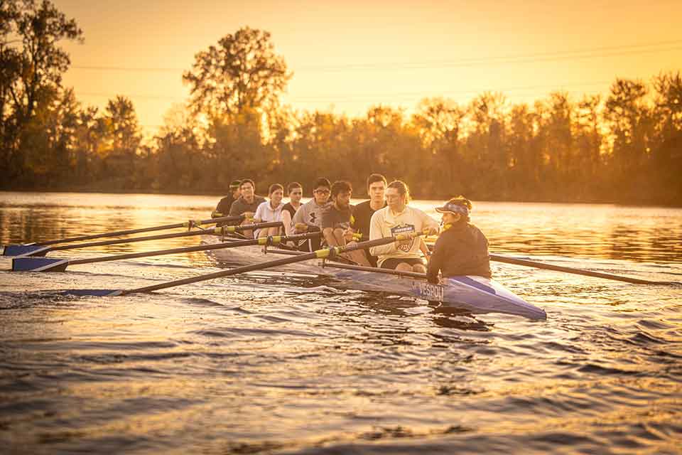 Members of SLU's rowing club out on the water when sun rises.